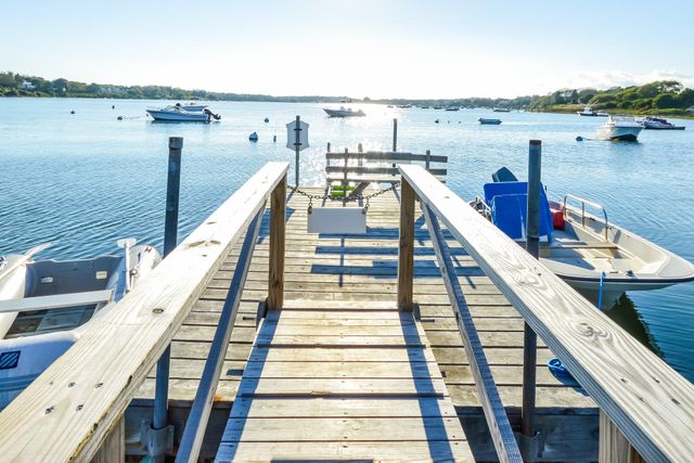 a view of a balcony with wooden chairs and two chairs