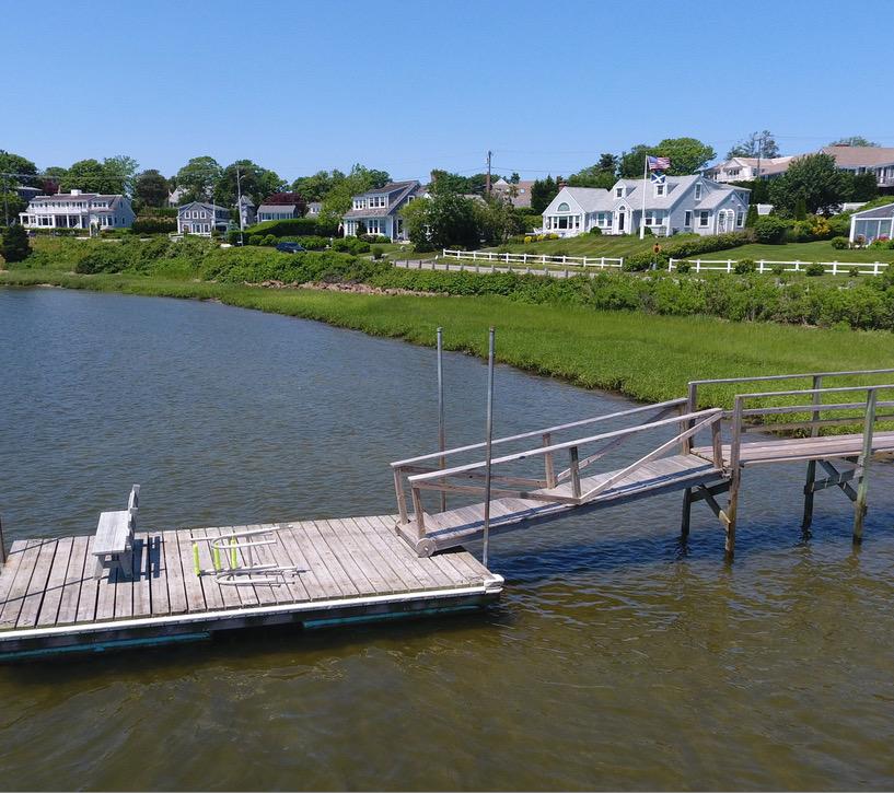 58 Pond Street Chatham, MA 02633 - Photo 16 of 38 a view of a lake with a yard and potted plants