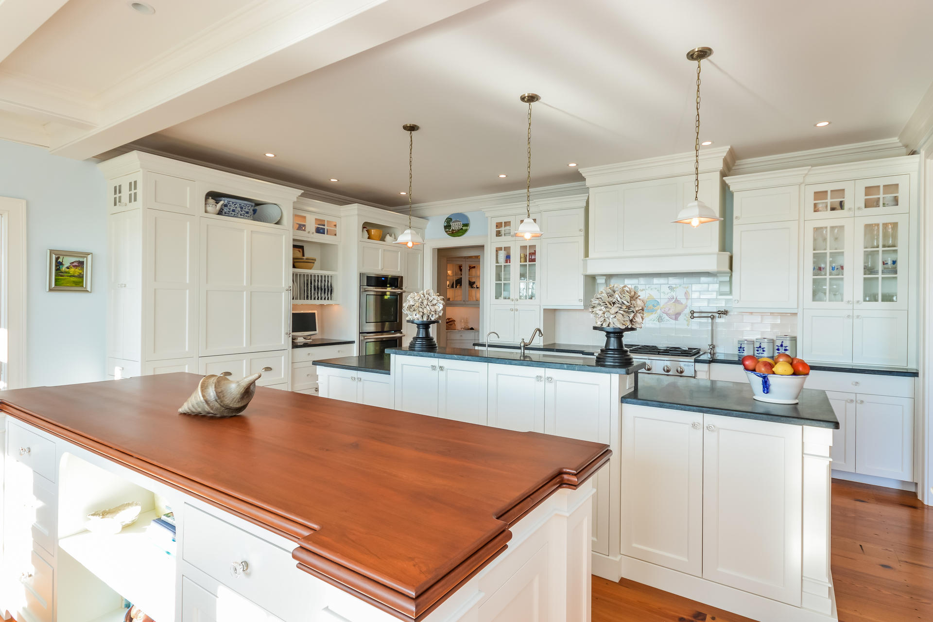 58 Pond Street Chatham, MA 02633 - Photo 23 of 38 a kitchen with stainless steel appliances a sink a stove a center island and wooden floor