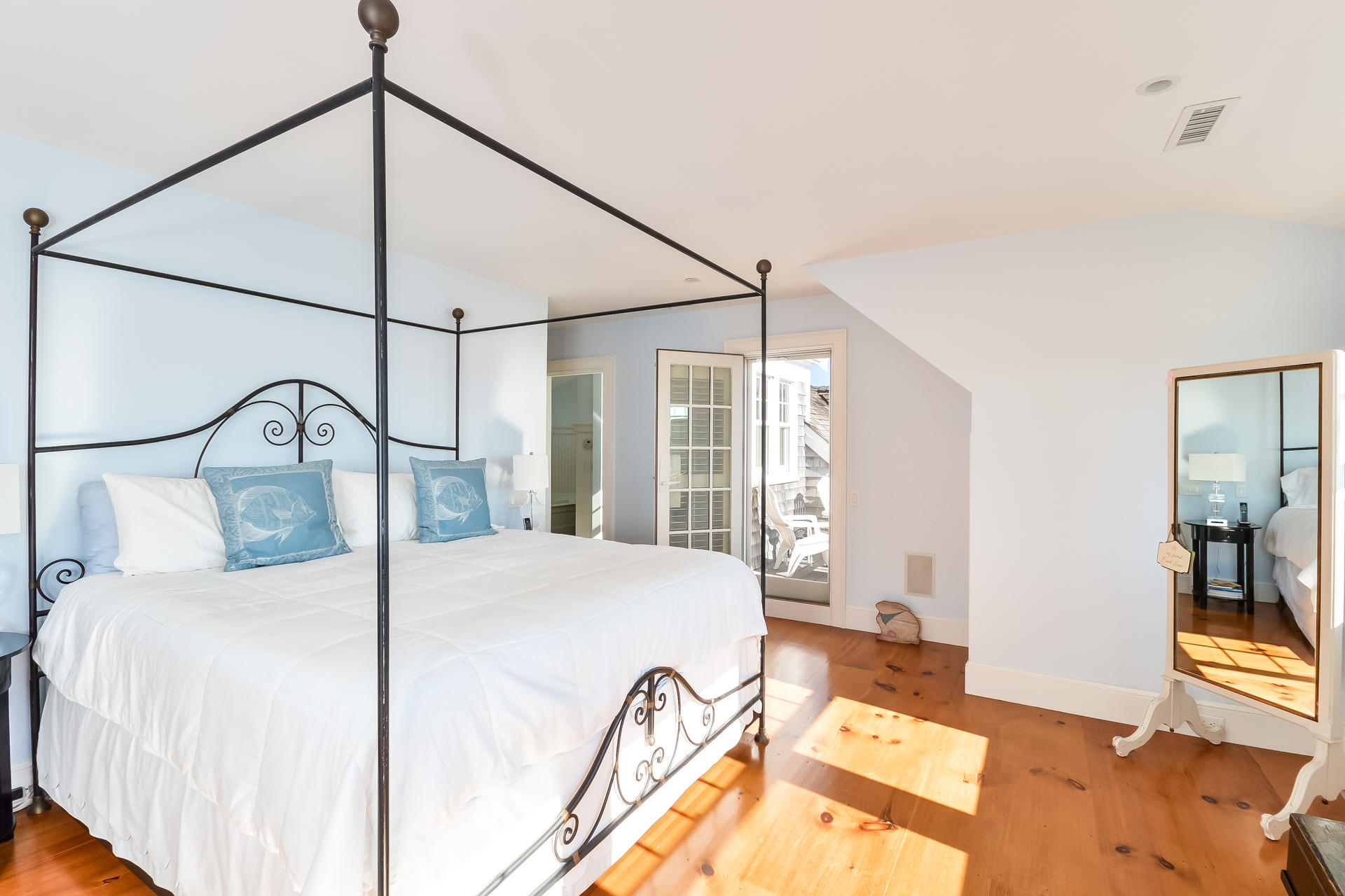 58 Pond Street Chatham, MA 02633 - Photo 29 of 38 a bedroom with a bed and a chandelier