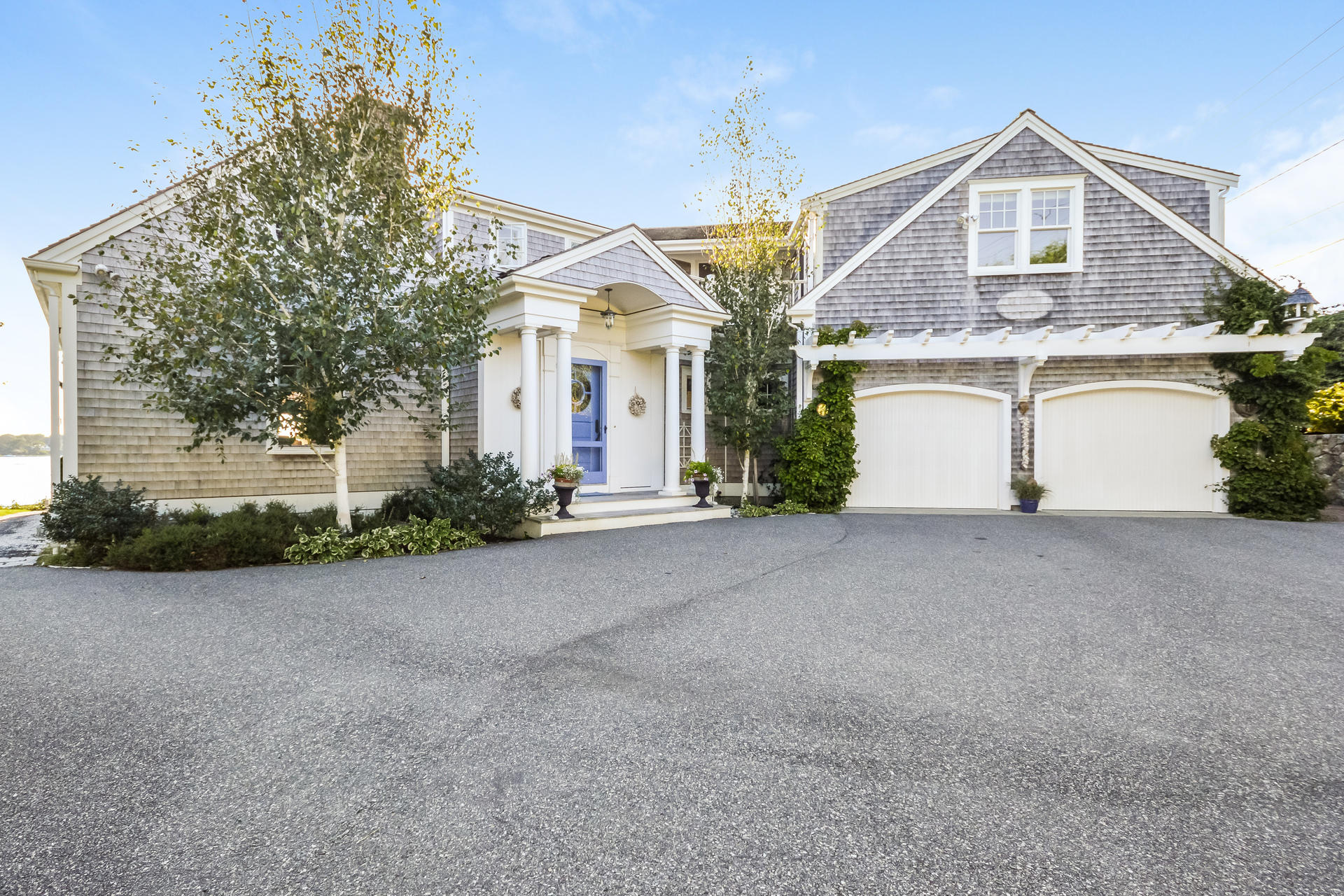 58 Pond Street Chatham, MA 02633 - Photo 6 of 38 a front view of a house with a yard and garage
