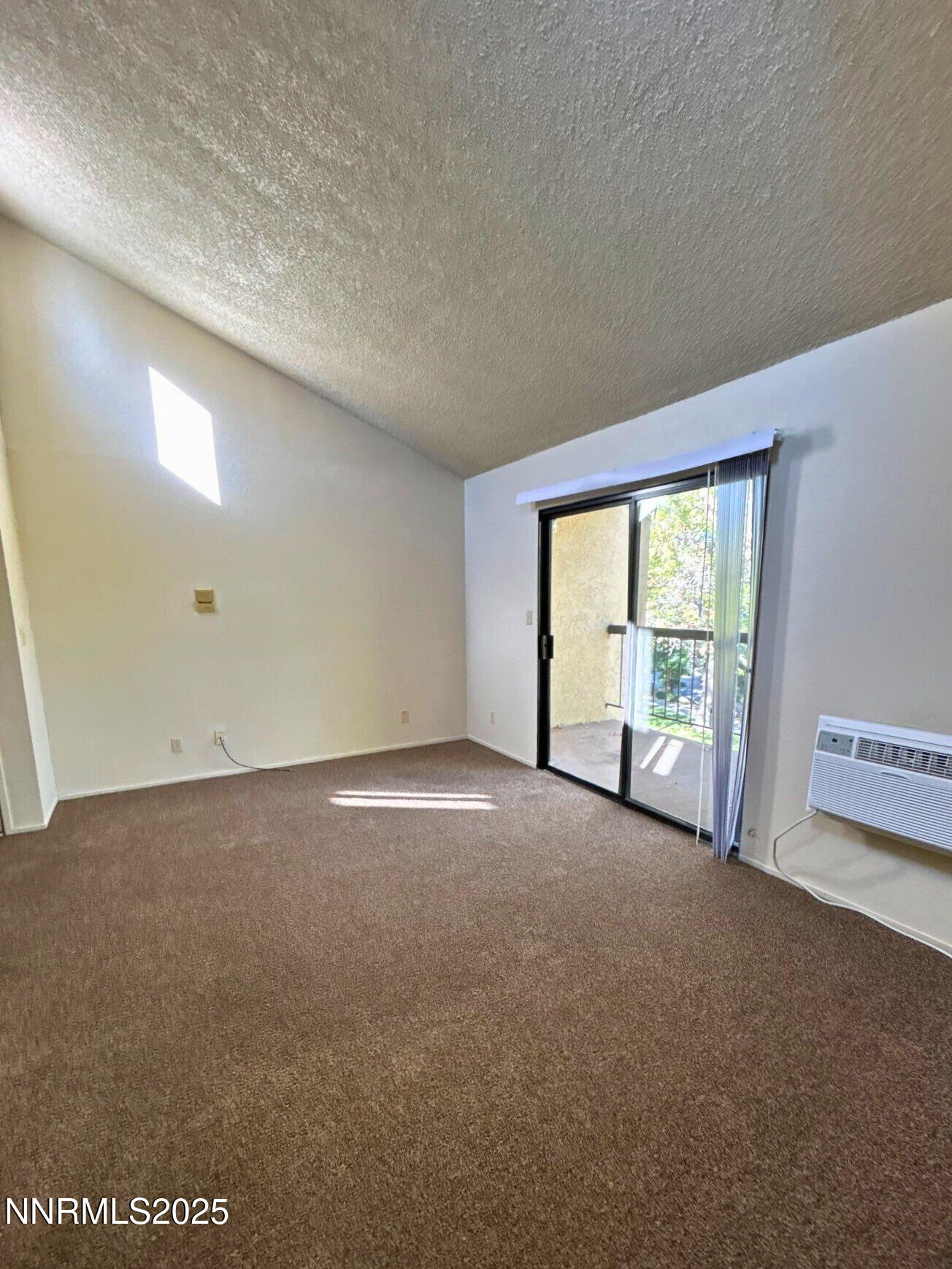 2450 Lymbery Street, Unit 311 Reno, NV 89509 - Photo 5 of 13 a view of an empty room with a balcony