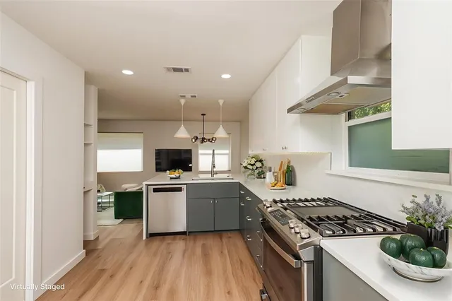 a kitchen with a stove and a sink