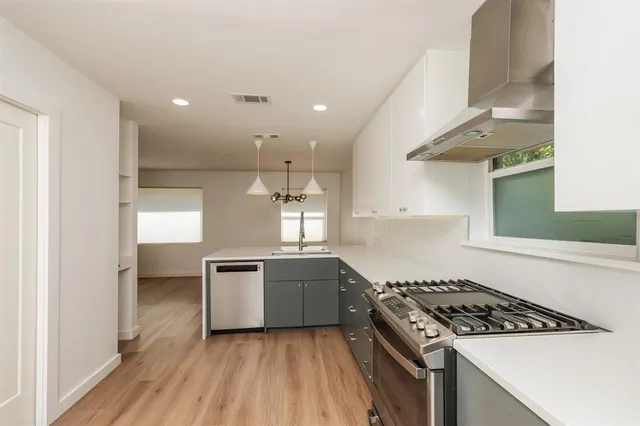 a kitchen with a stove and a sink