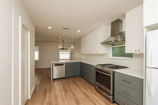 a kitchen with granite countertop a stove and a refrigerator