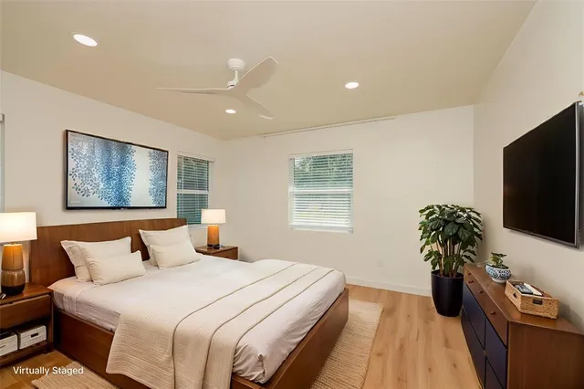 a bedroom with bed and a flat screen tv