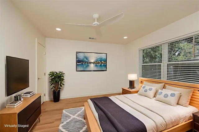 a bedroom with a bed and a flat screen tv