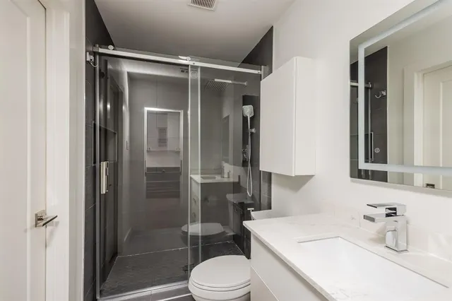 a bathroom with a sink toilet and shower
