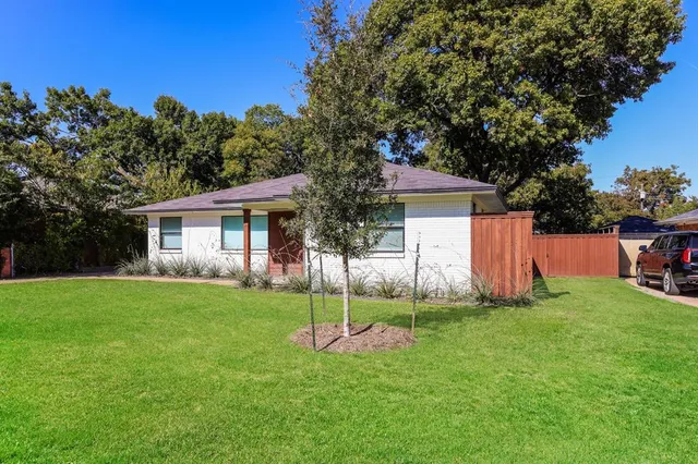 a view of a house with a yard and porch
