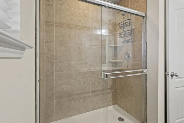 a bathroom with a glass shower door