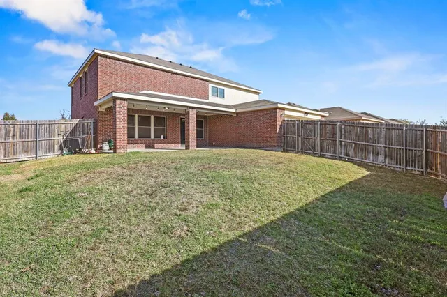 a view of a house with a yard and sitting area
