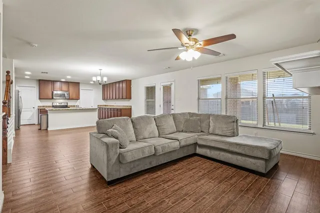 a living room with furniture and a large window