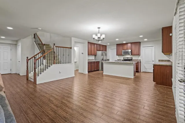 a view of kitchen with cabinets and wooden floor