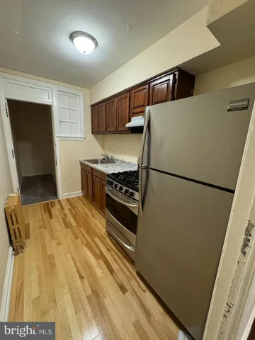 a kitchen with a refrigerator and a stove