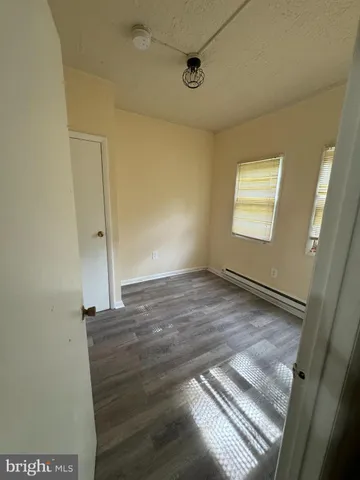 a view of a room with wooden floor and window