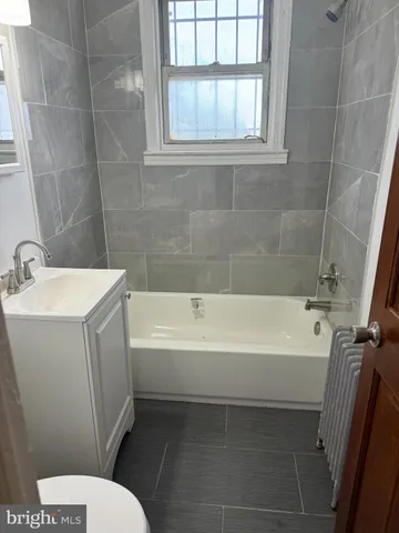 a bathroom with a sink a toilet and bathtub