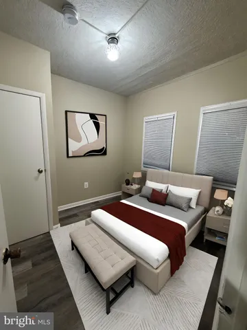 a bedroom with a bed and a night stand