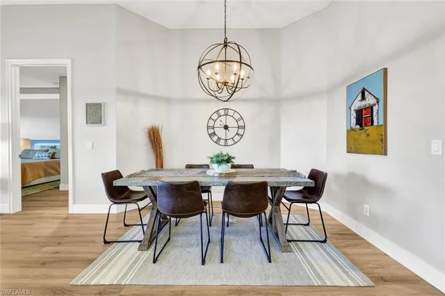 a view of a dining room with furniture wooden floor and a chandelier