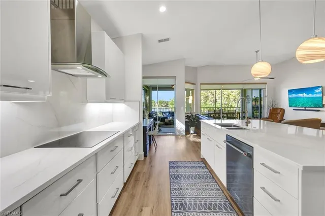 a large white kitchen with a large window