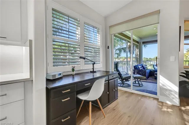 a dining room with furniture and wooden floor