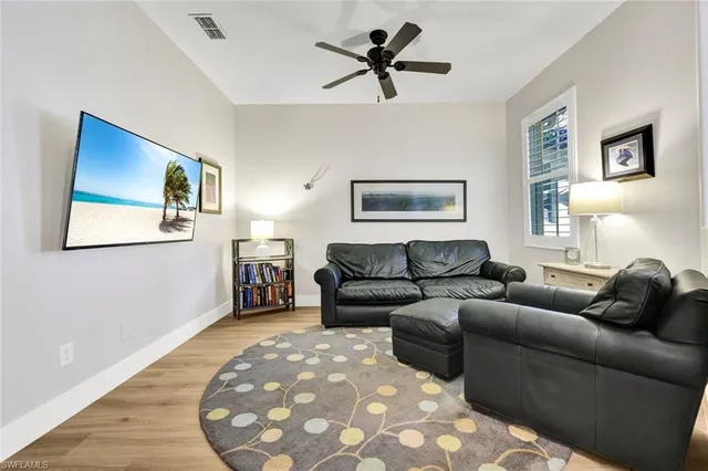 a living room with furniture and wooden floor