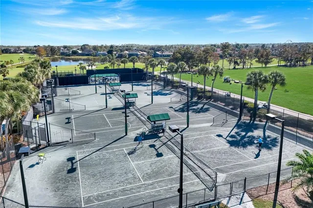 an aerial view of a city with lots of residential buildings ocean and mountain view in back