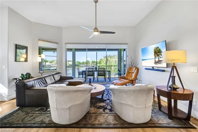 a living room with furniture and a floor to ceiling window