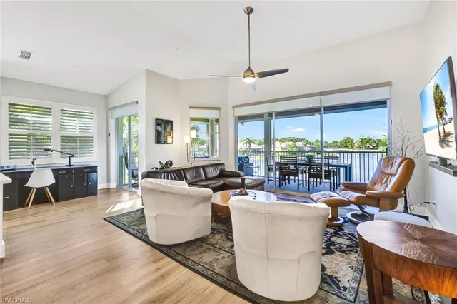 a living room with furniture and large windows