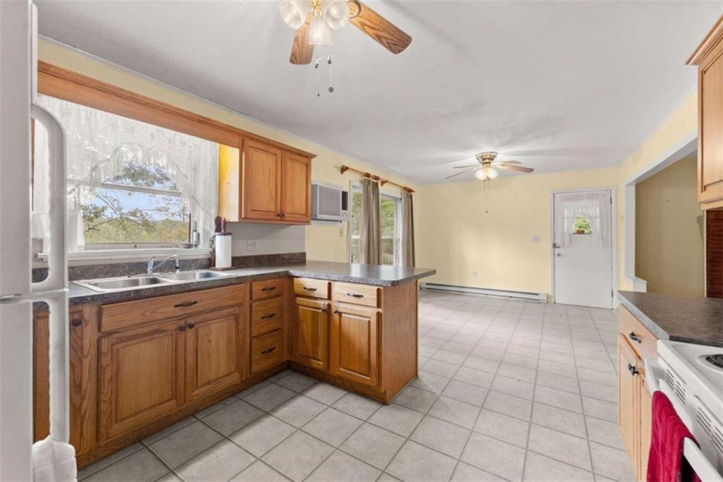 3772 Ledan Road Gainesville, GA 30506 - Photo 11 of 33 a kitchen with stainless steel appliances granite countertop a stove top oven a sink dishwasher and a refrigerator with wooden floor