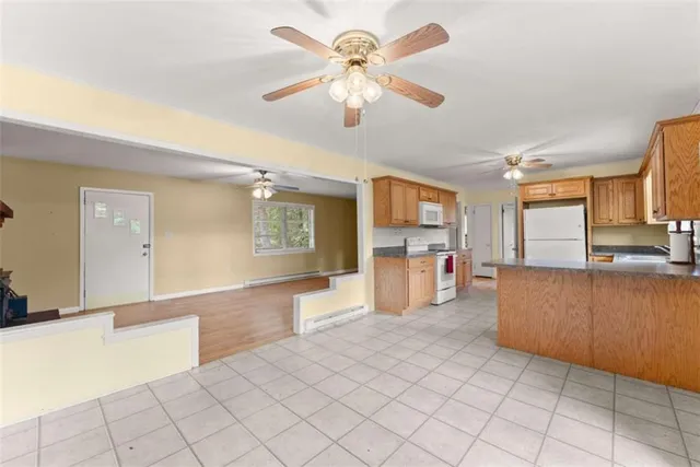 a open kitchen with cabinets and a stove top oven