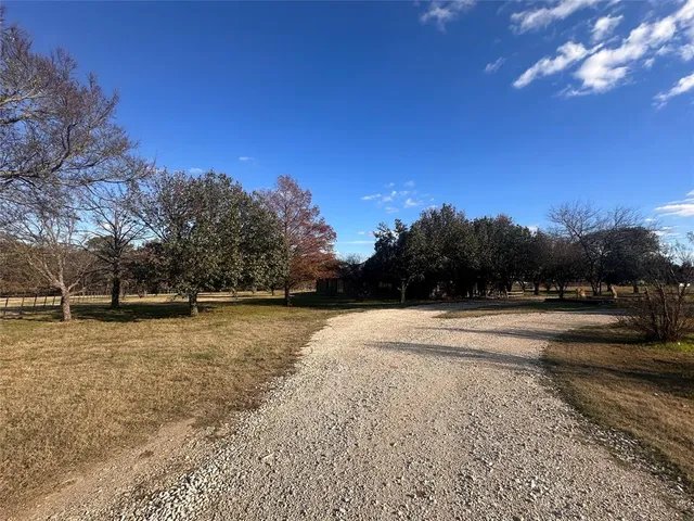 a view of a yard with a house in the background