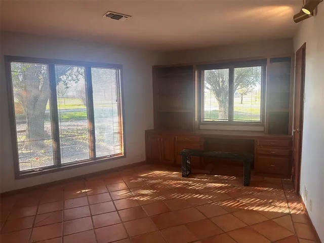 an empty room with a empty space and windows