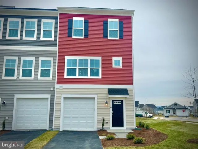 a view of a brick house with a yard