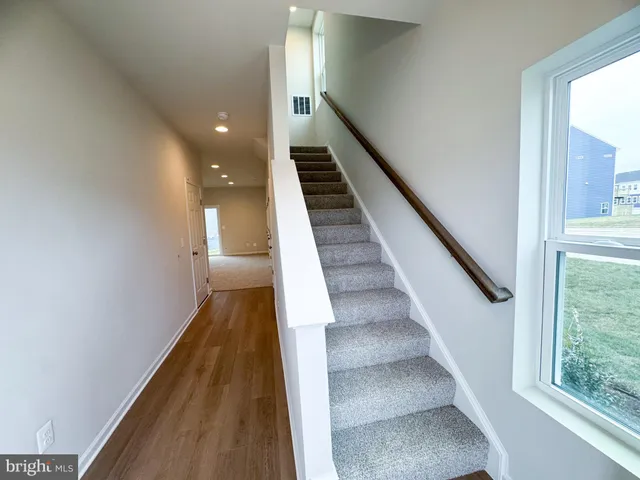 a view of entryway and hall with wooden floor