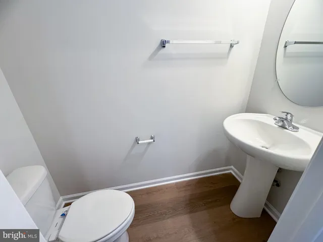 a bathroom with a sink mirror and toilet