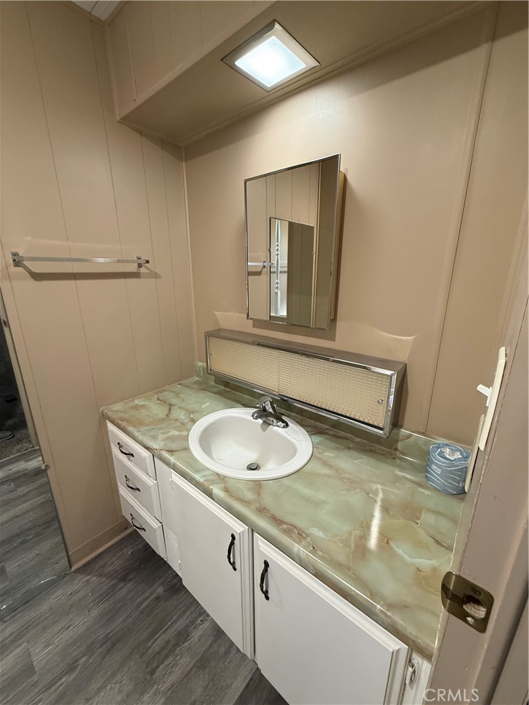 2240 Golden Oak Lane, Unit 108 Merced, CA 95341 - Photo 21 of 30 a bathroom with a granite countertop sink a mirror and vanity