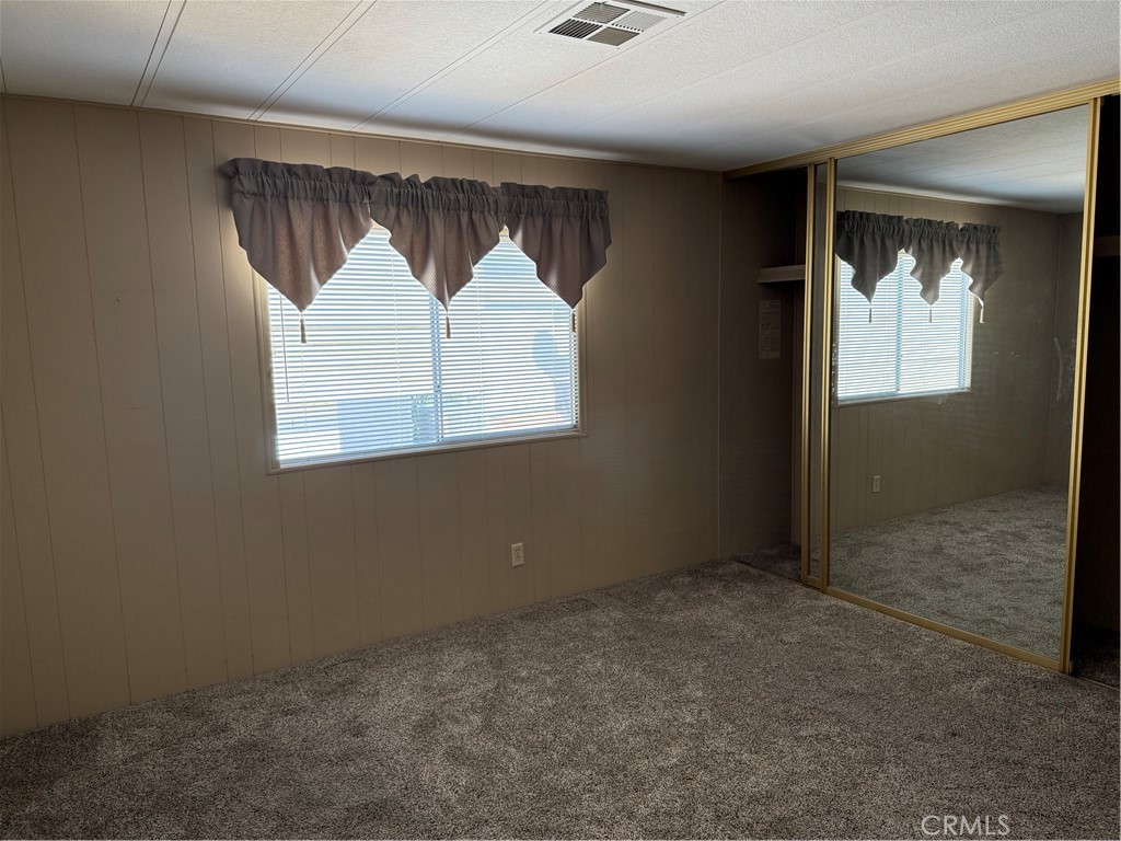 2240 Golden Oak Lane, Unit 108 Merced, CA 95341 - Photo 22 of 30 an empty room with wooden floor and windows