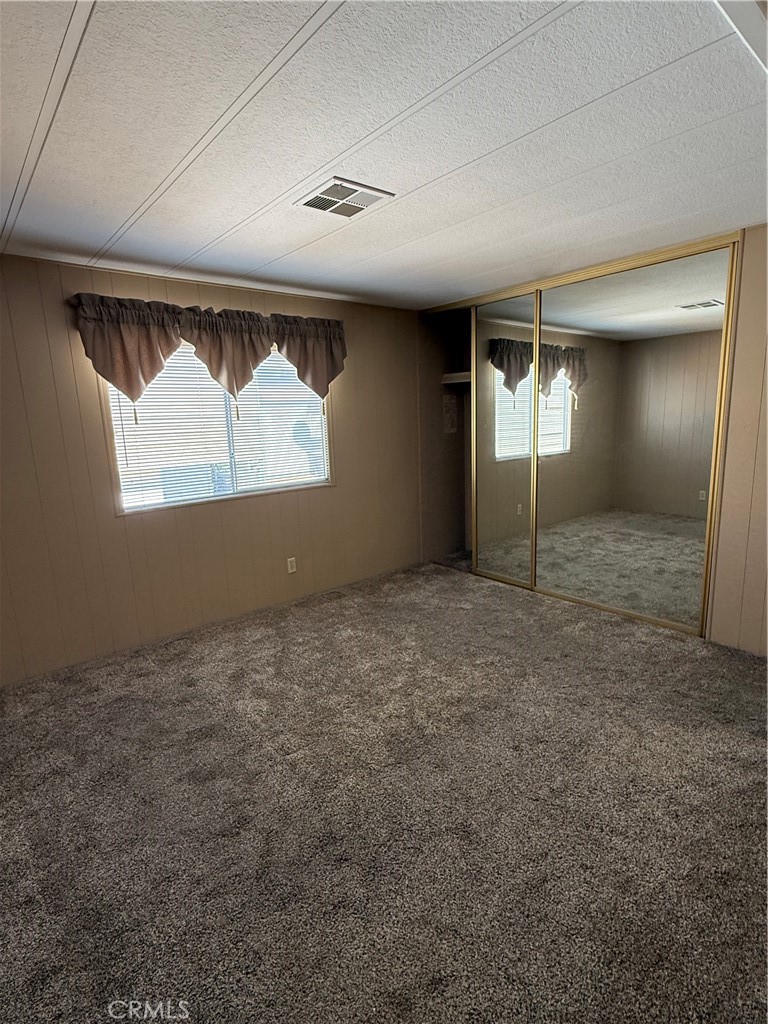 2240 Golden Oak Lane, Unit 108 Merced, CA 95341 - Photo 27 of 30 an empty room with windows and closet