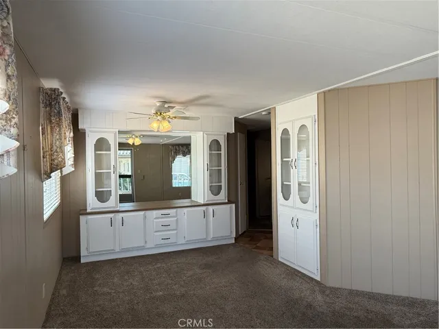 a view of an entryway with wooden floor and cabinet