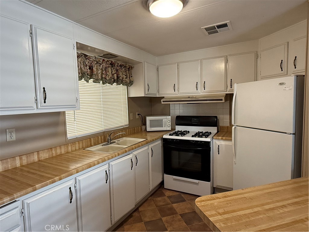 2240 Golden Oak Lane, Unit 108 Merced, CA 95341 - Photo 10 of 30 a kitchen with a stove a refrigerator and a sink
