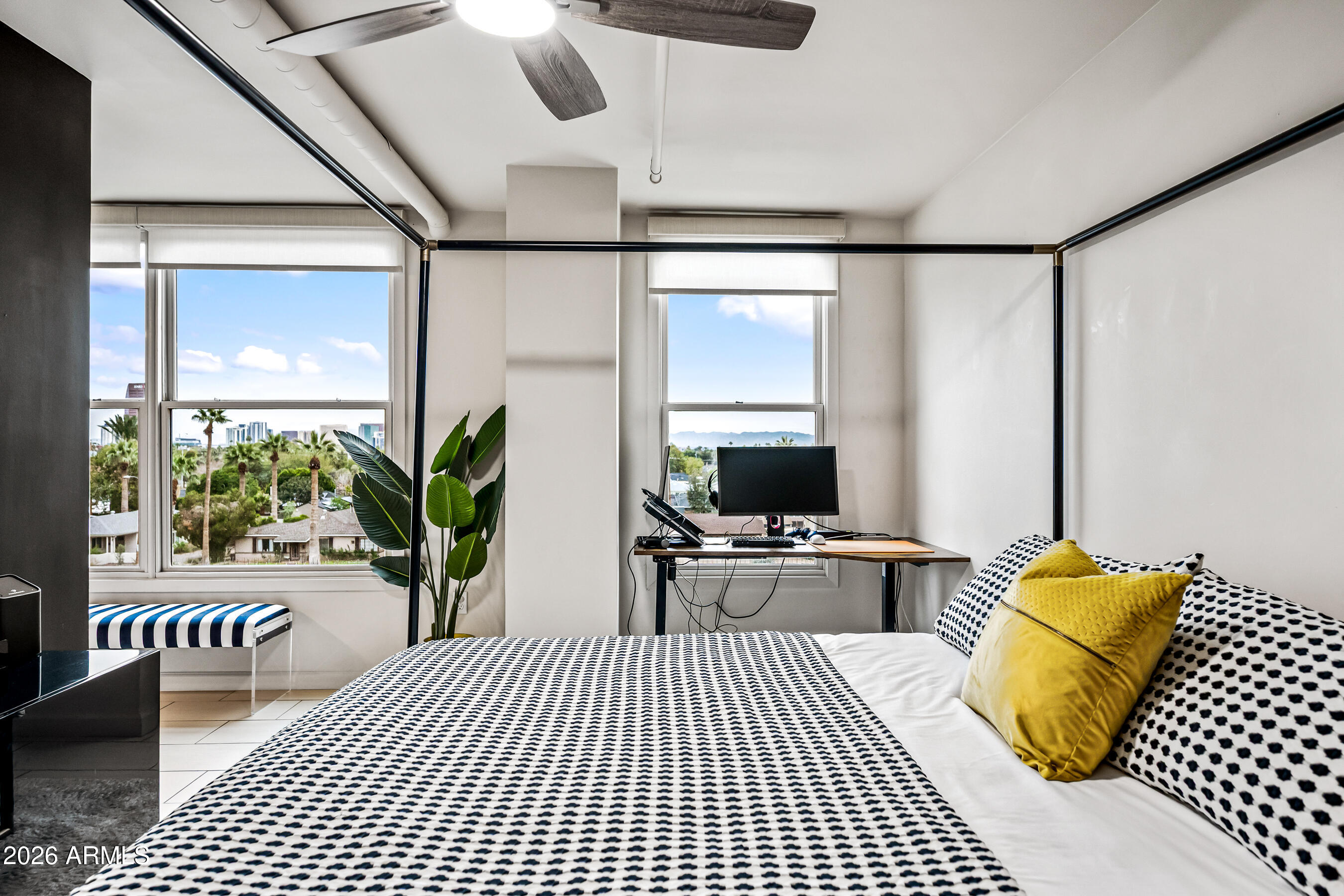 535 West Thomas Road, Unit 407 Phoenix, AZ 85013 - Photo 18 of 42 a bedroom with a large bed and a chandelier