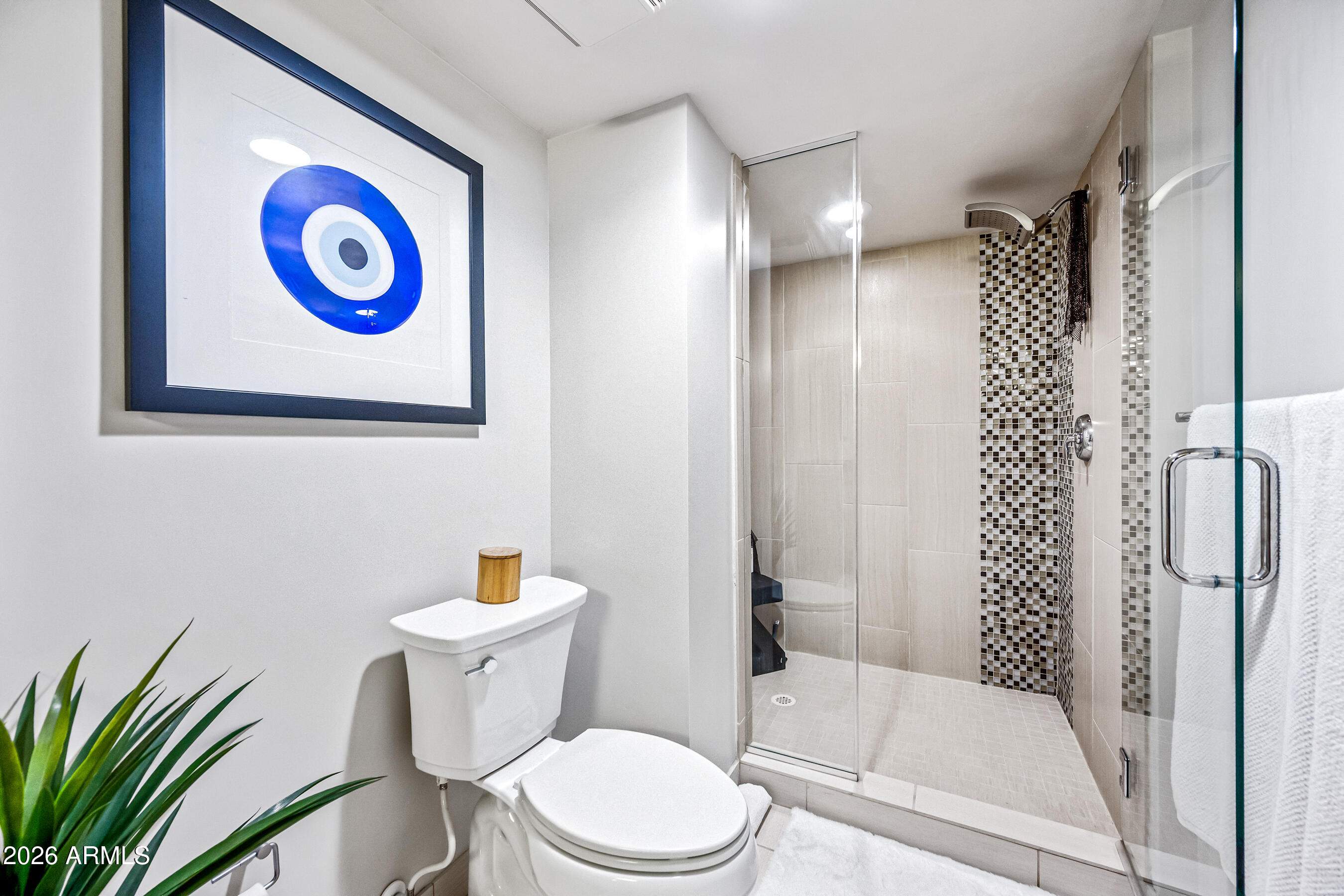 535 West Thomas Road, Unit 407 Phoenix, AZ 85013 - Photo 21 of 42 a white toilet sitting next to a bathroom sink and a shower