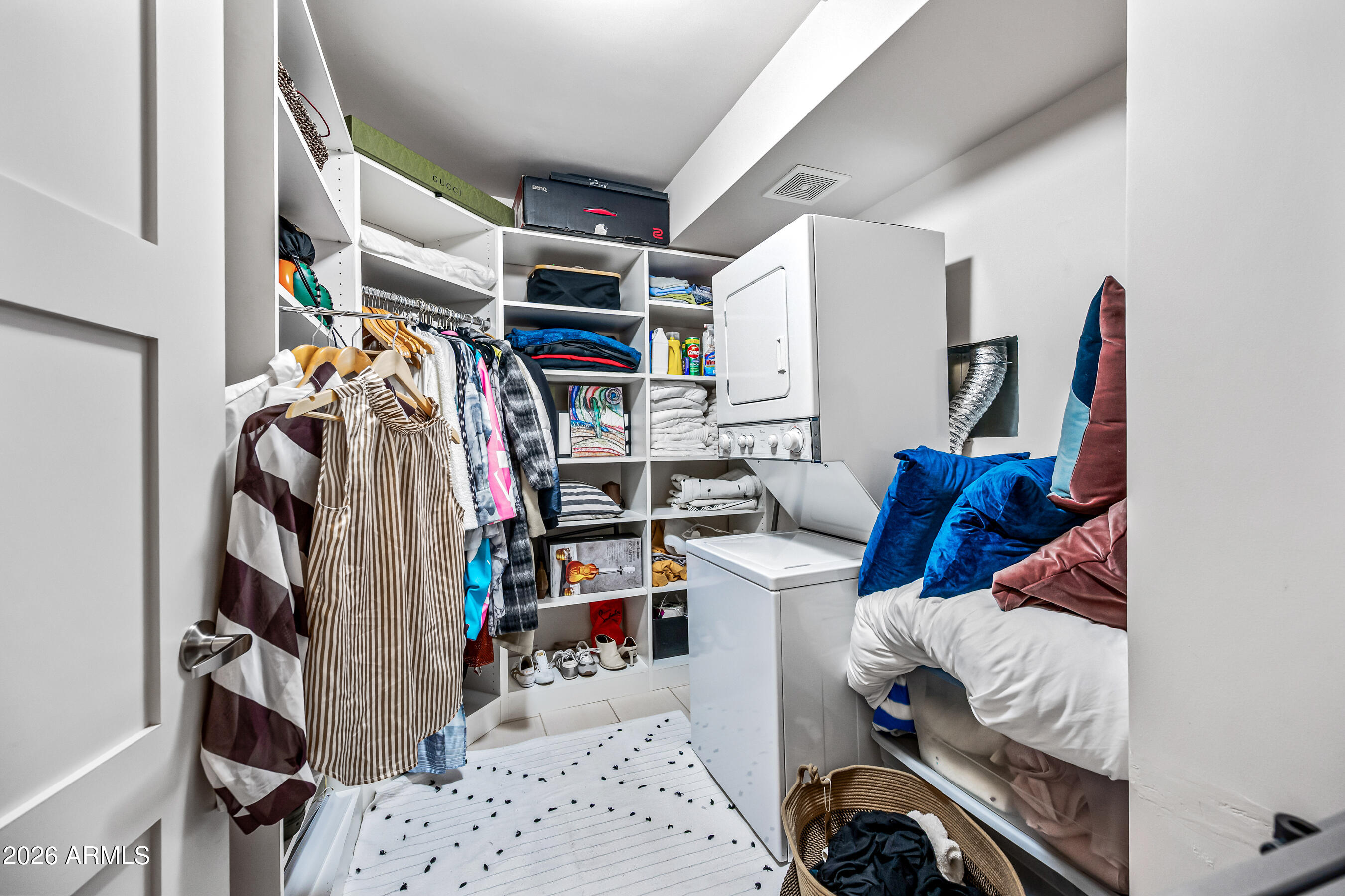 535 West Thomas Road, Unit 407 Phoenix, AZ 85013 - Photo 24 of 42 a view of walk in closet with clothes and shoes