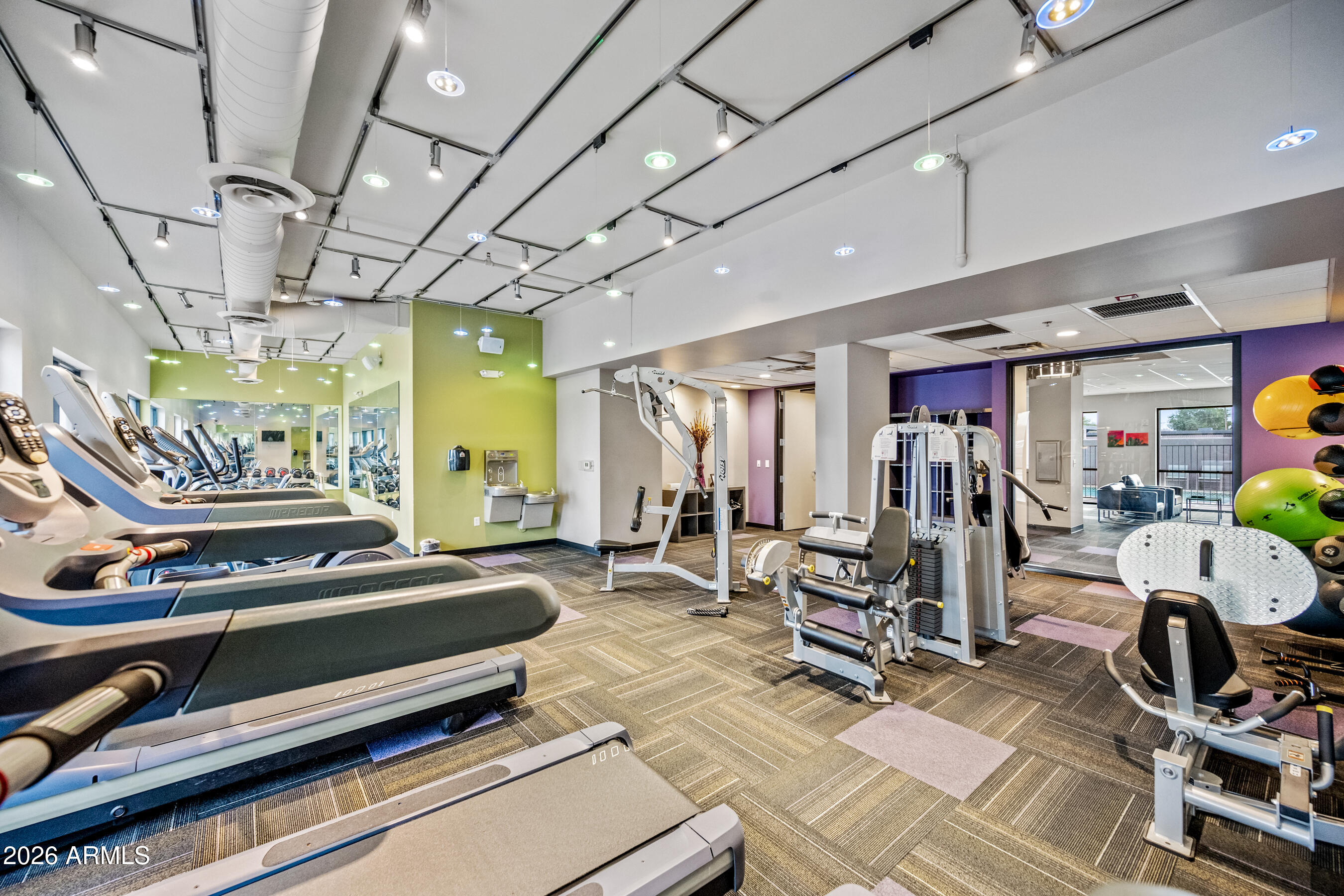 535 West Thomas Road, Unit 407 Phoenix, AZ 85013 - Photo 38 of 42 a room with gym equipment and a large window