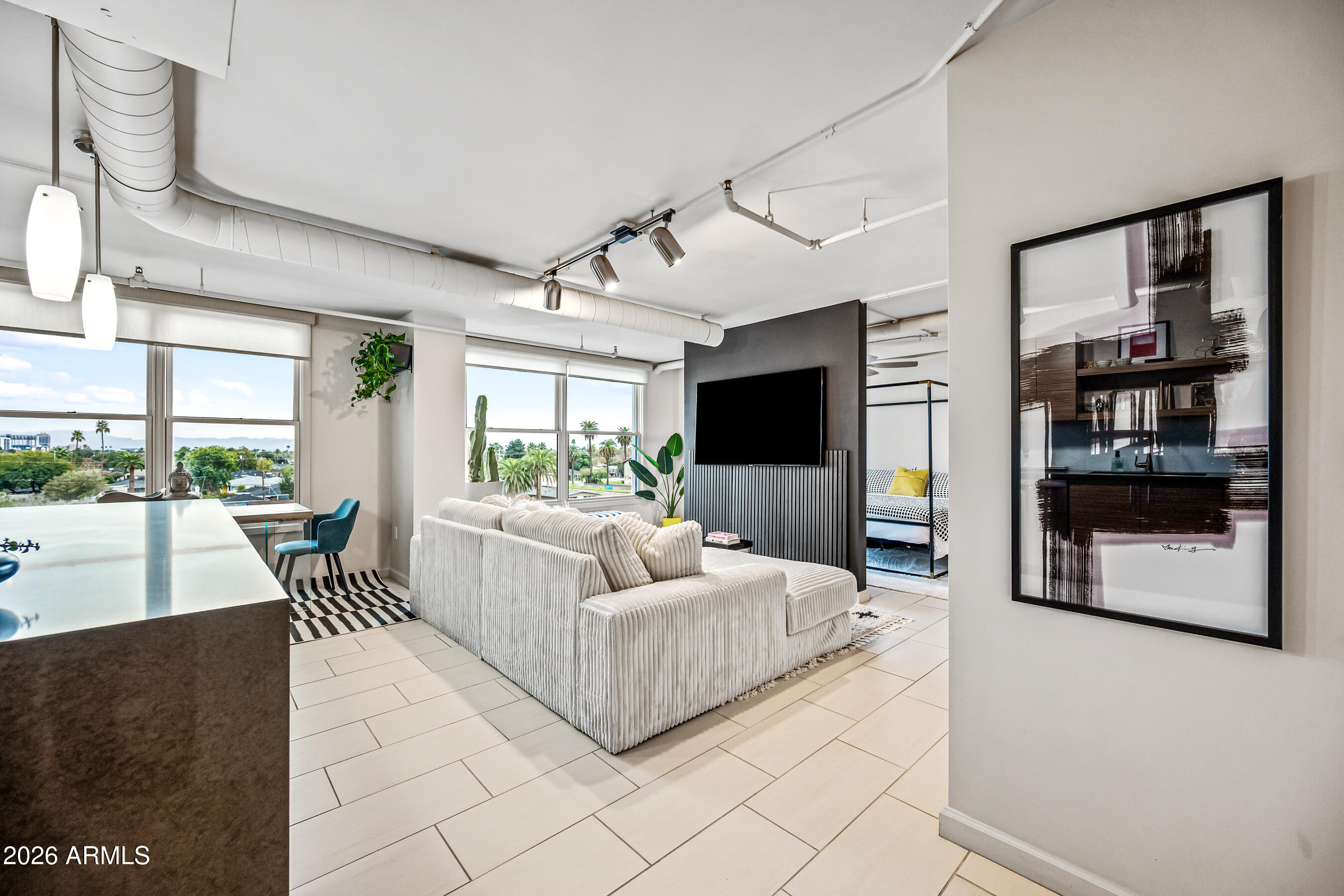 535 West Thomas Road, Unit 407 Phoenix, AZ 85013 - Photo 4 of 42 a living room with furniture and a flat screen tv