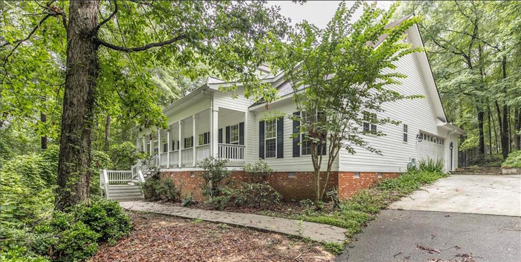 805 Pate Road Juliette, GA 31046 - Photo 1 of 1 a view of a white house with a tree and plants