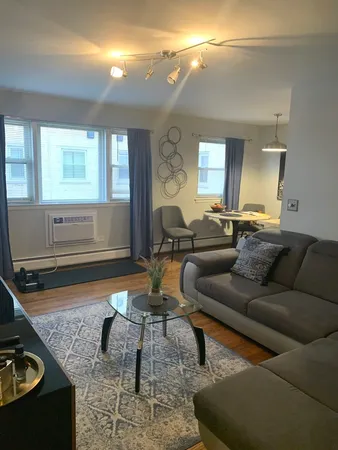 a living room with furniture and a window