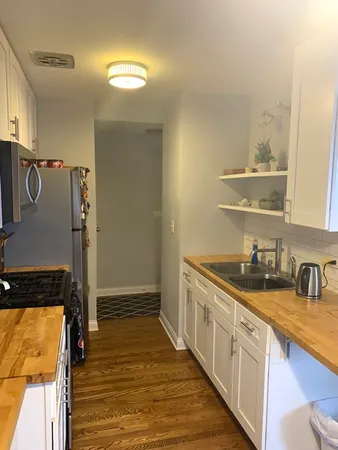 a kitchen with granite countertop a sink and cabinets