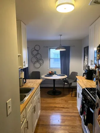 a kitchen that has a lot of cabinets a sink and a stove