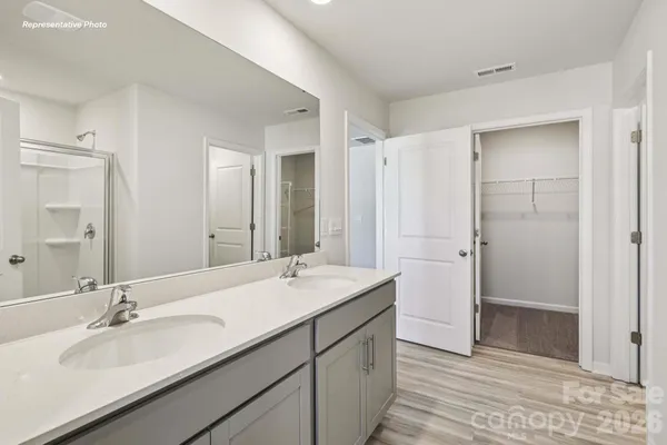 a bathroom with a double vanity sink mirror and double